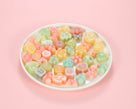 Classic one-bite wax bottle candies by Oodles in various colors filled with fruit juice