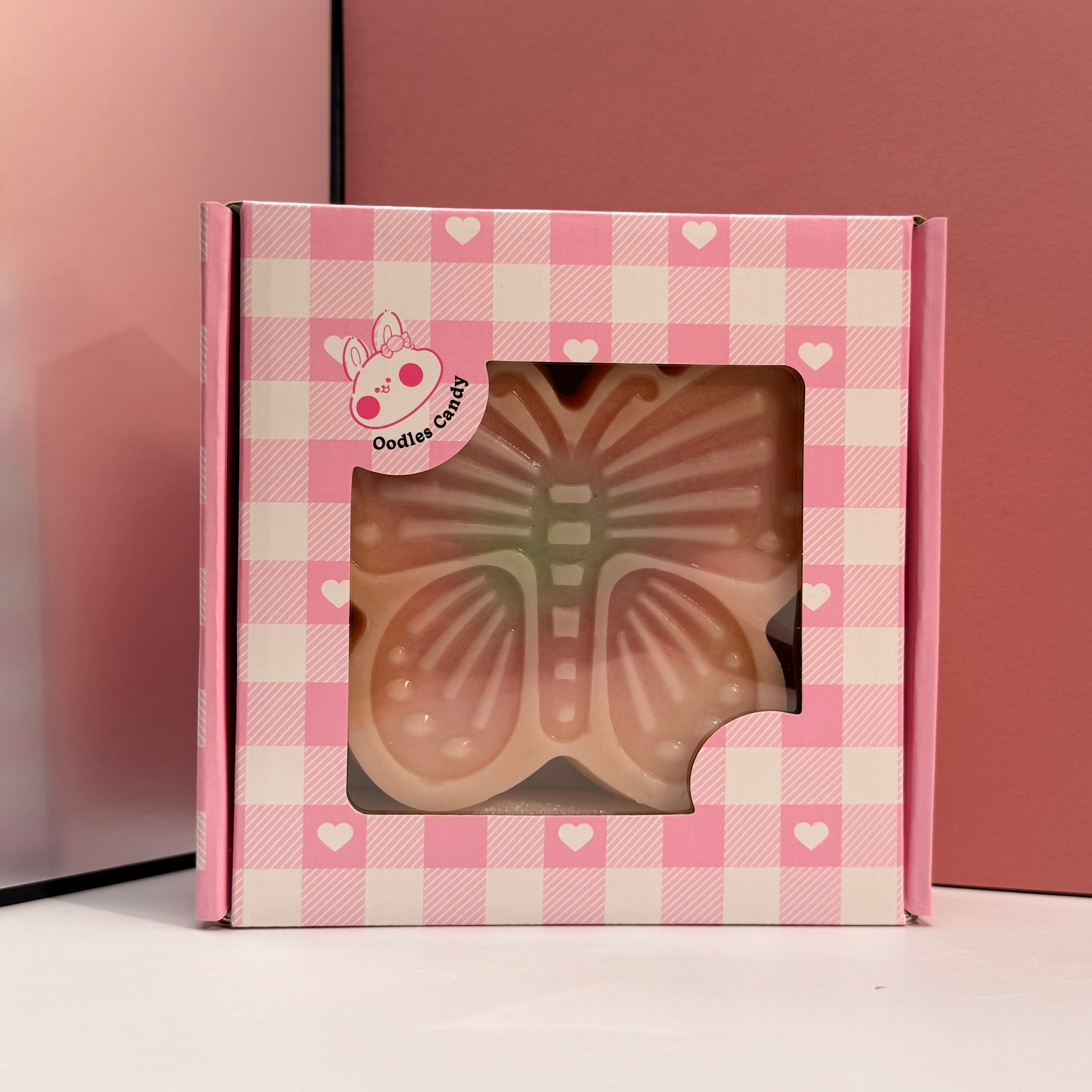 Close up of handmade butterfly wax candy showing delicate wing details and fruit juice inside