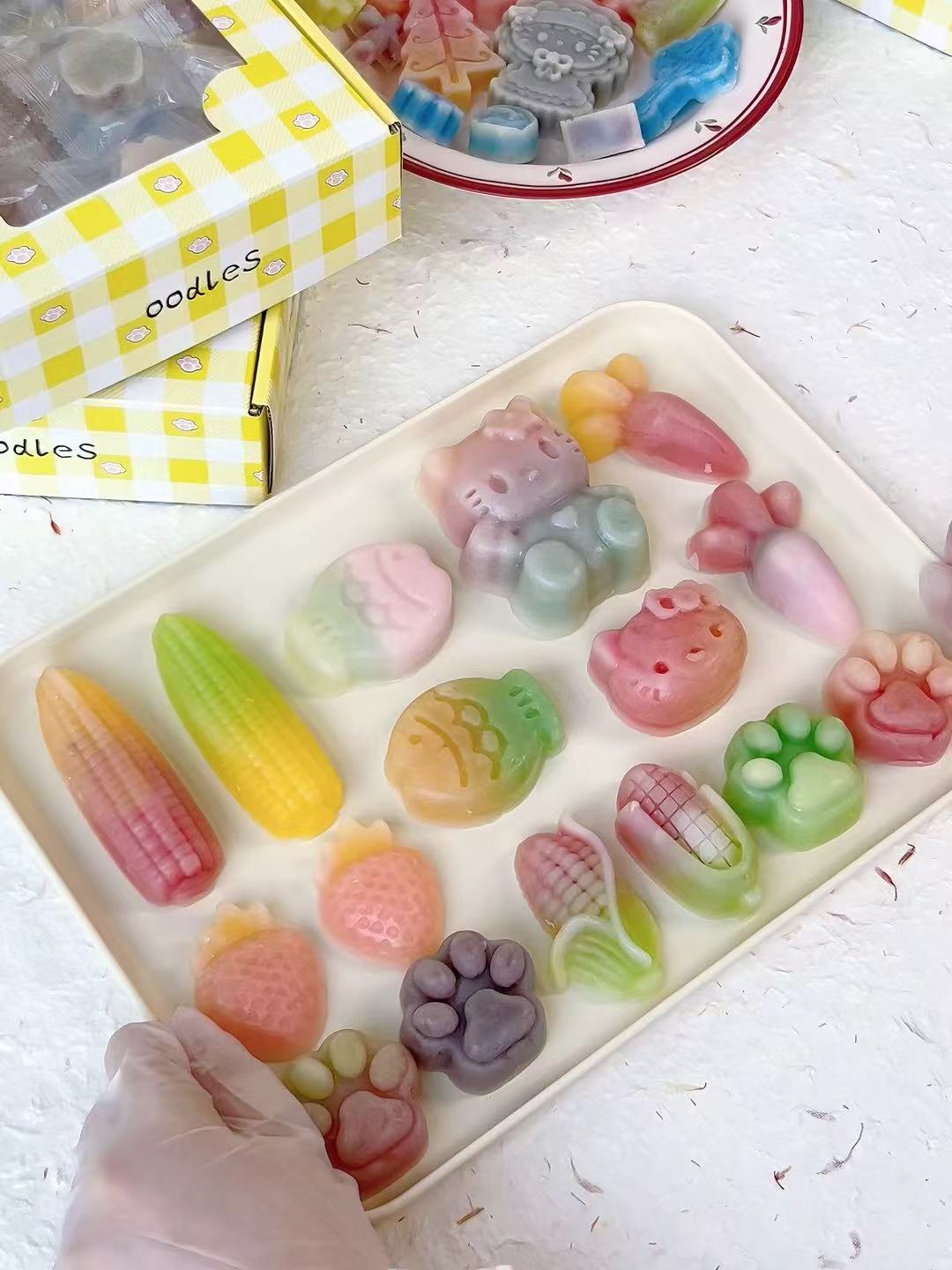 Close up of individually wrapped wax bottle candy pieces in various fun shapes from Oodles bulk box